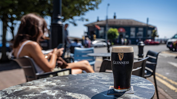 Pint of Guiness with White Star Office in the background